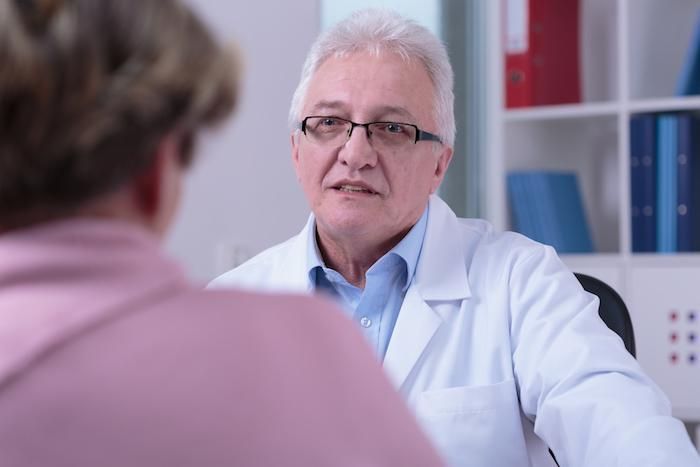 senior male doctor with patient