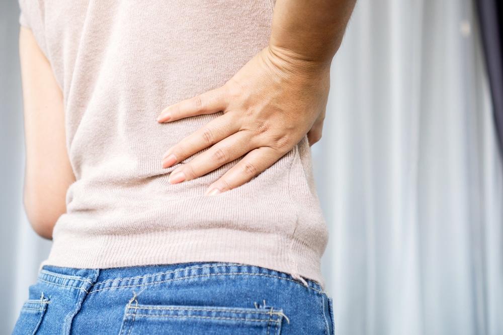 Woman,Suffering,From,Lower,Back,Pain,,Hand,Holding,Right,Side 2251e8eb91844a9d9f68169dc594a518 Back Pain Specialist in East Brunswick, NJ